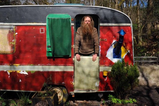 Gwilym, a 55-year-old who arrived at the camp three years ago, looks out from his caravan